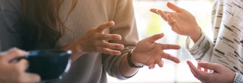 Hands of two people signing during a BSL conversation.